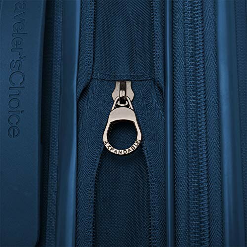 Close-up of blue luggage zipper with expandable feature.