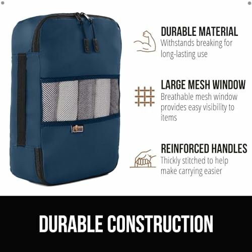 Blue travel packing cube with mesh window and reinforced handles.