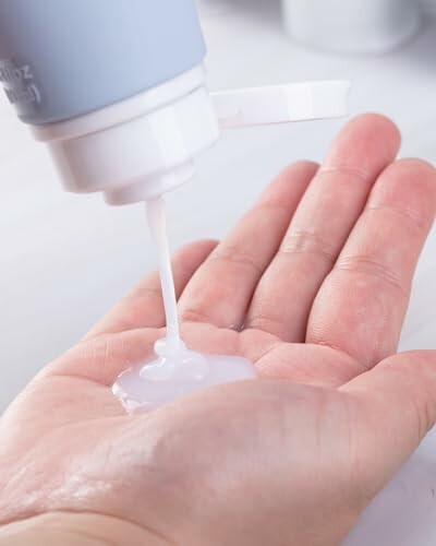 Person applying lotion to hand