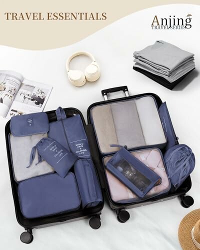 Open suitcase with neatly packed travel essentials and folded clothes.