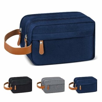 Set of four toiletry bags in blue, black, gray, and light gray with leather handles.